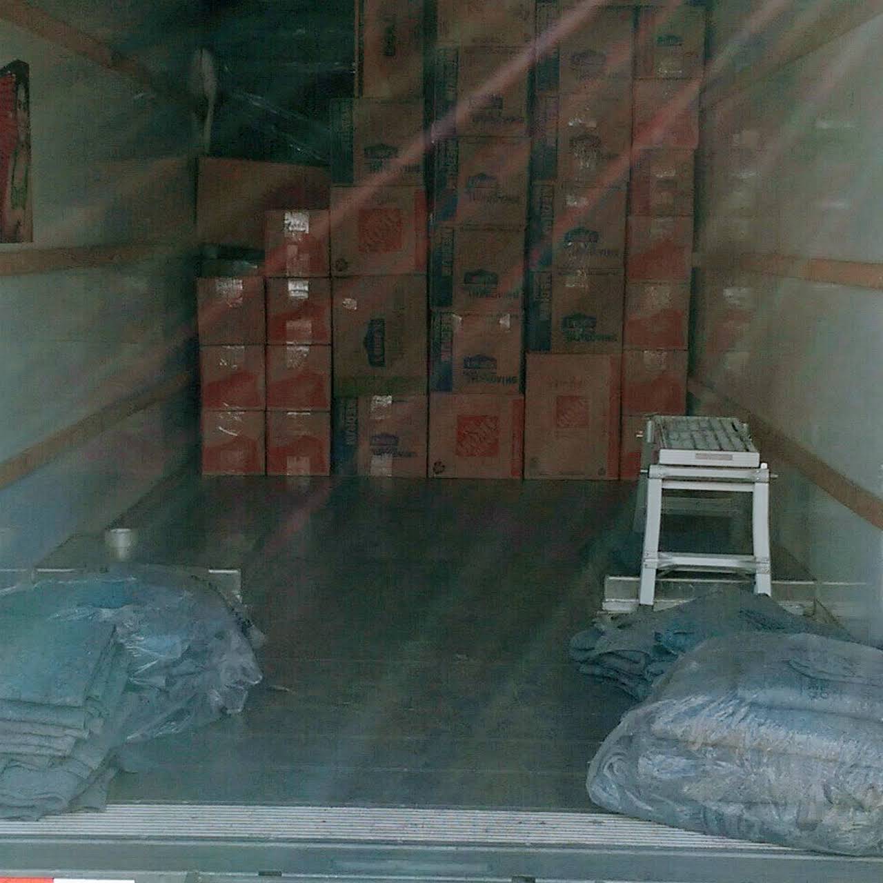 The back of a moving truck filled with boxes.